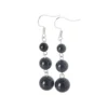 Aretes de plata con obsidiana natural, contraste profundo y presencia serena. Una pieza de carácter esencial.