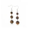 Aretes de plata con ojo de tigre natural y profundidad cálida. Una joya de carácter equilibrado.