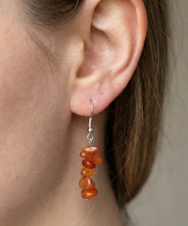 Aretes de plata con cornalina natural, tonos terrosos y presencia equilibrada. Una pieza sobria de carácter mineral.